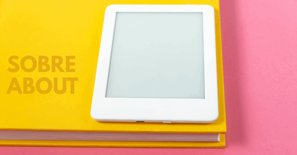 Mesa cor de rosa, com livro amarelo e ereader branco. Ao fundo do livro amarelo se lê o texto "SOBRE / ABOUT"